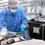 employee working in cleanroom packaging