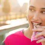 Woman eating a cold-seal packaged nutrition bar